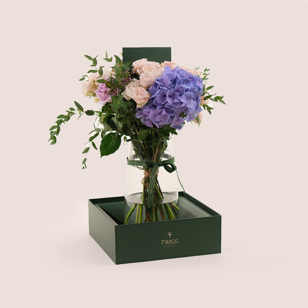 Lavender Elegance in a Flower Vase – A Refined Mix of Purple Hydrangea, Roses, and Wax Flowers