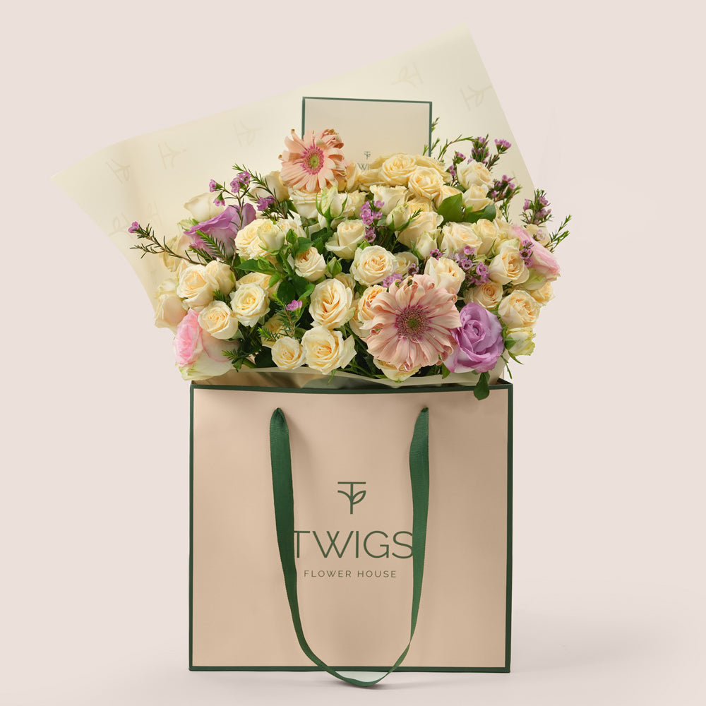 Peach Harmony Mother’s Day flower arrangement with peach gerberas and roses in TWIGS signature flower bag