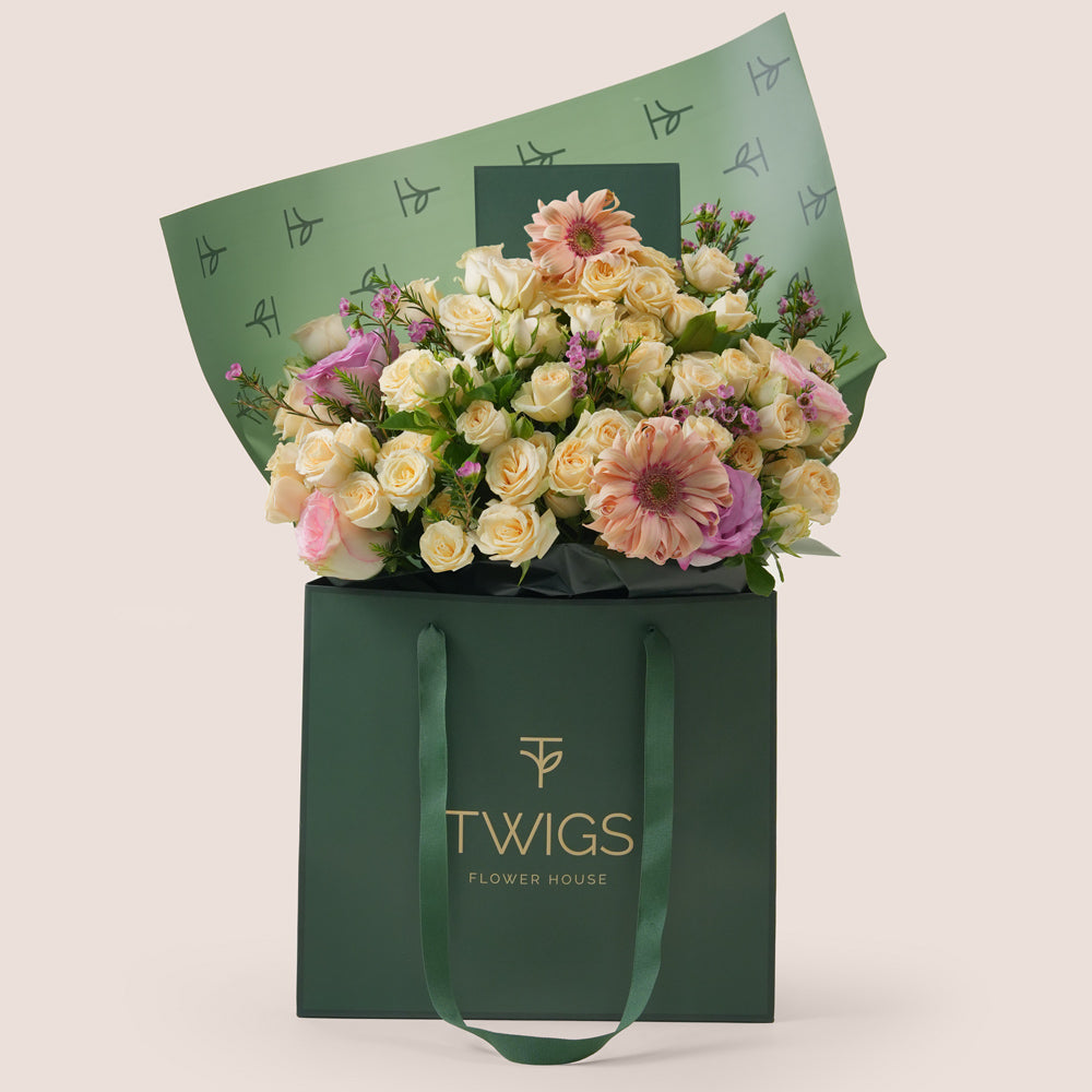 Peach Harmony Mother’s Day flower arrangement with peach gerberas and roses in TWIGS signature flower bag