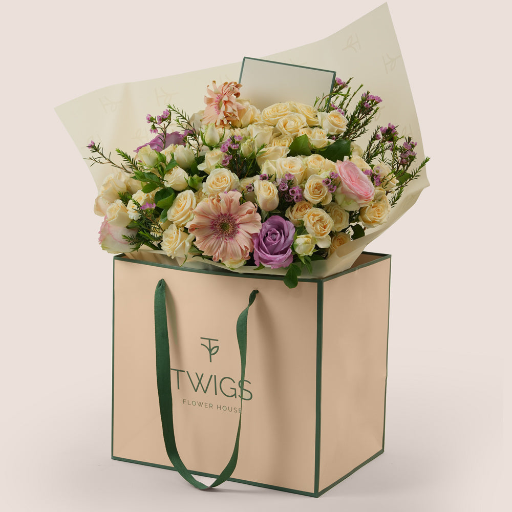 Peach Harmony Mother’s Day flower arrangement with peach gerberas and roses in TWIGS signature flower bag