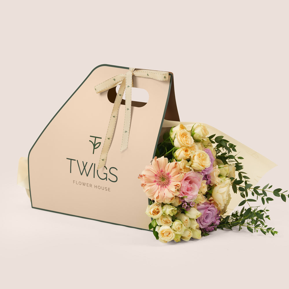 Peach Harmony Mother’s Day flower bouquet with peach gerberas and roses in TWIGS flower bunch carry pack