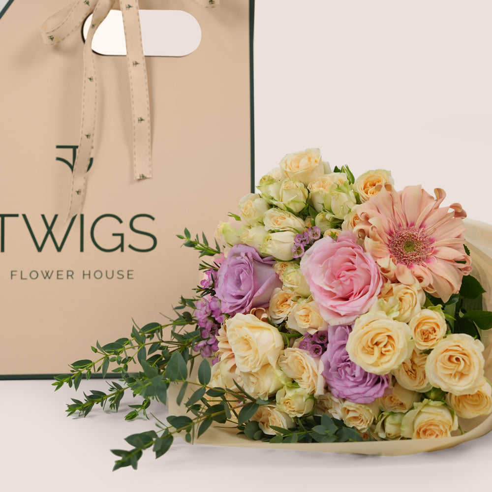 Peach Harmony Mother’s Day flower bouquet with peach gerberas and roses in TWIGS flower bunch carry pack