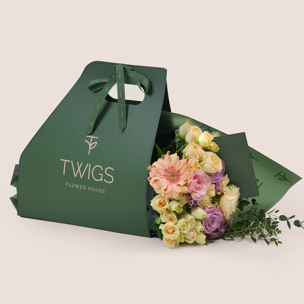 Peach Harmony Mother’s Day flower bouquet with peach gerberas and roses in TWIGS flower bunch carry pack