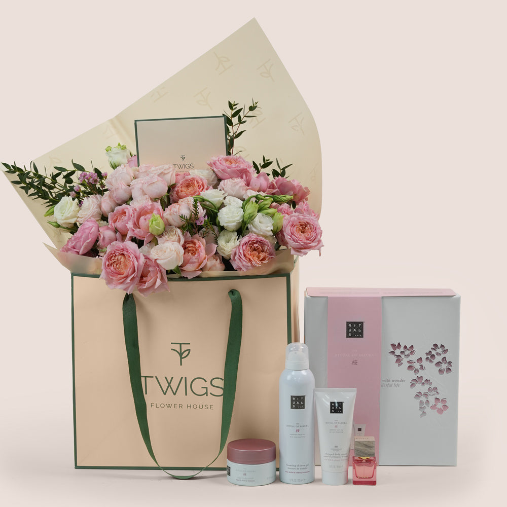 Blushing Bloom Mother’s Day flower arrangement in TWIGS flower bag paired with Rituals Sakura gift set