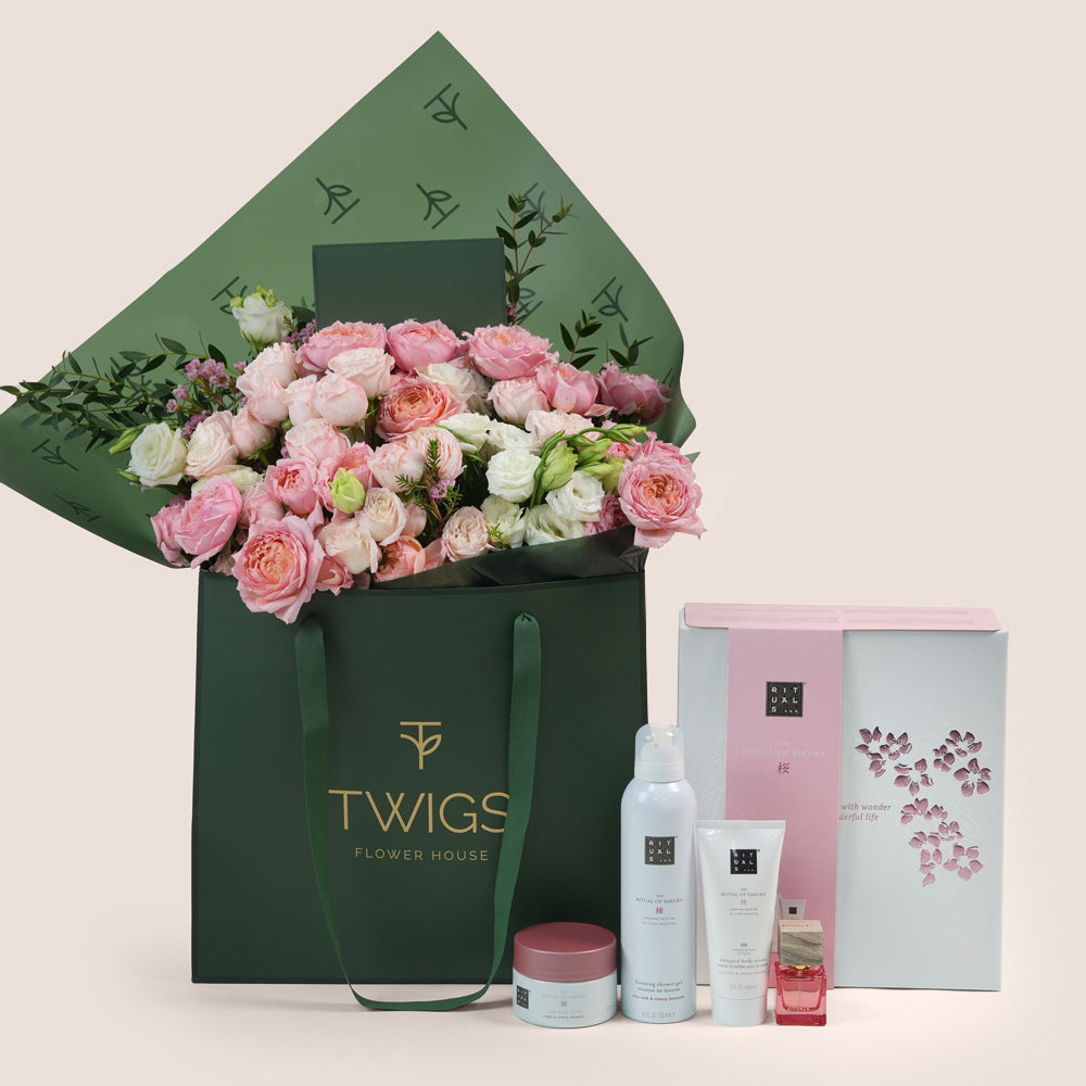 Blushing Bloom Mother’s Day flower arrangement in TWIGS flower bag paired with Rituals Sakura gift set