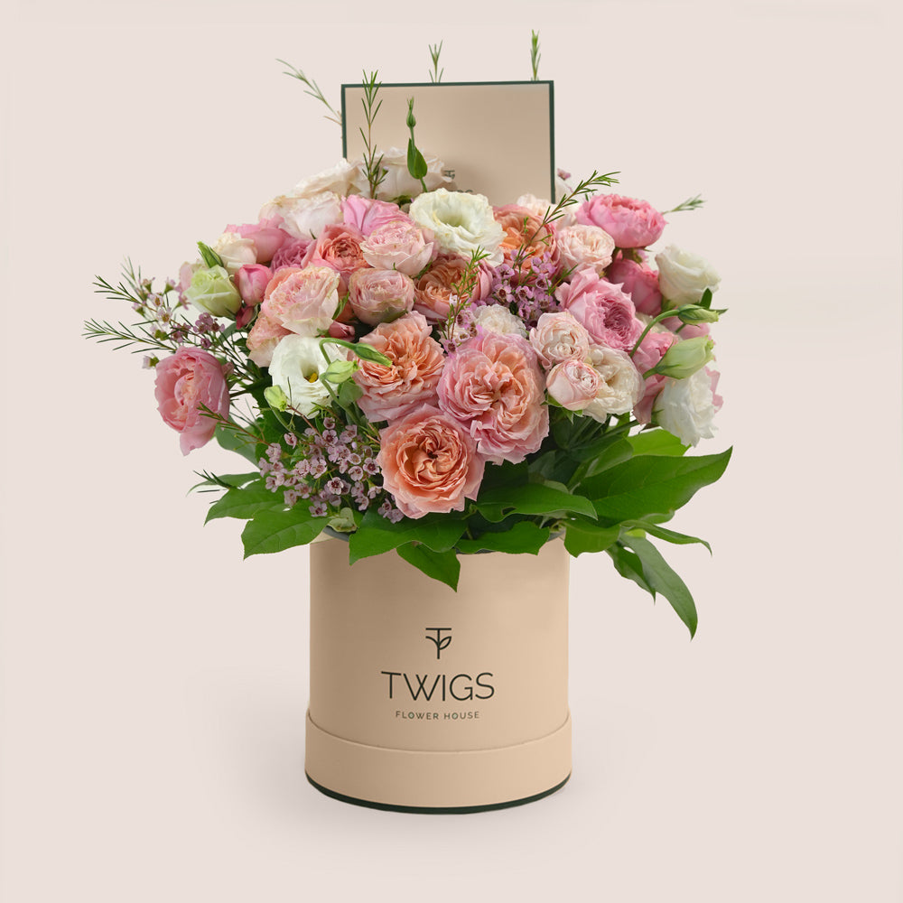 Blushing Bloom Mother’s Day flower arrangement with Juliet spray roses and white lisianthus in TWIGS deluxe round flower box