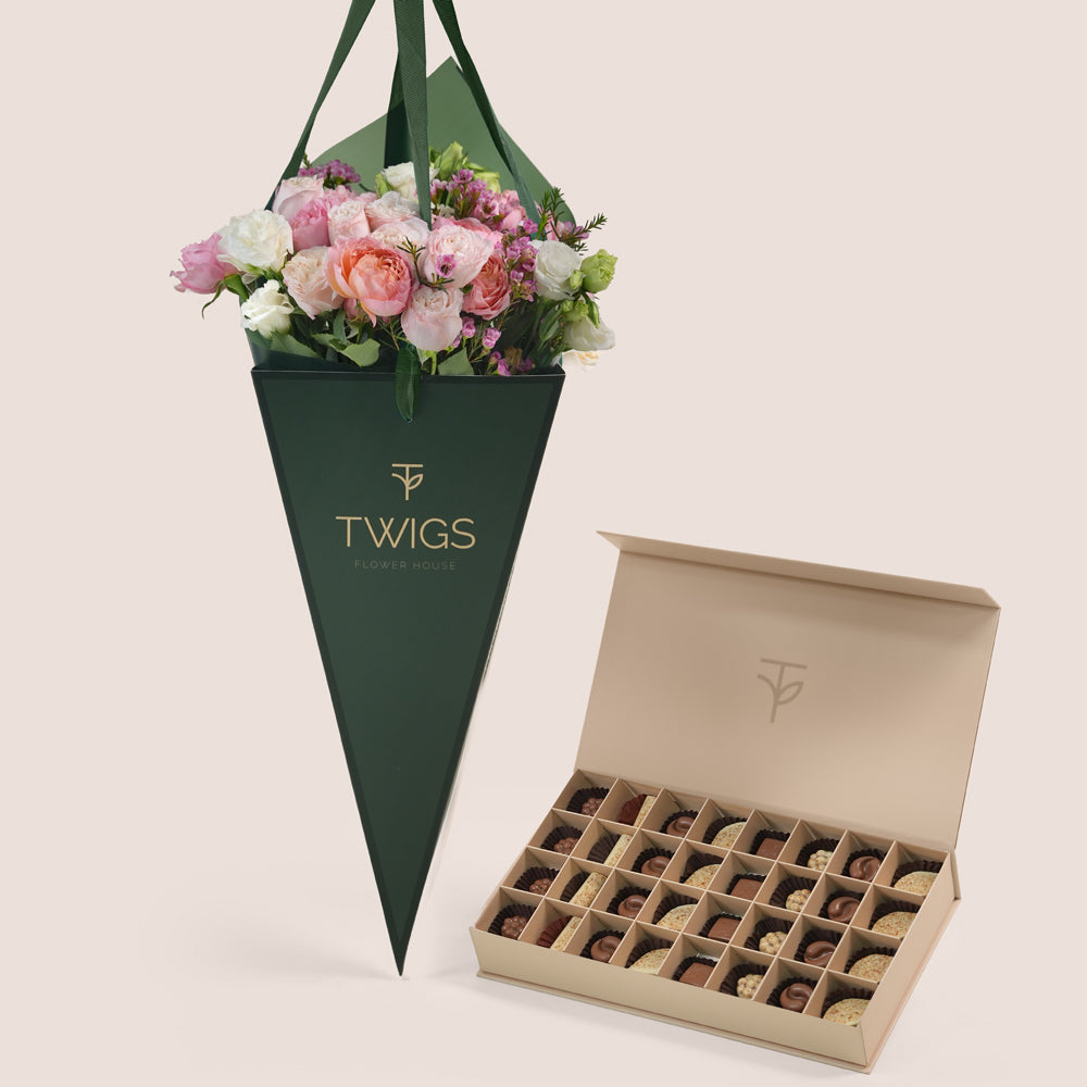 Blushing Bloom flower arrangement in TWIGS cone bag paired with 32 piece premium chocolate gift box