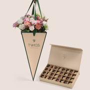 Blushing Bloom flower arrangement in TWIGS cone bag paired with 32 piece premium chocolate gift box