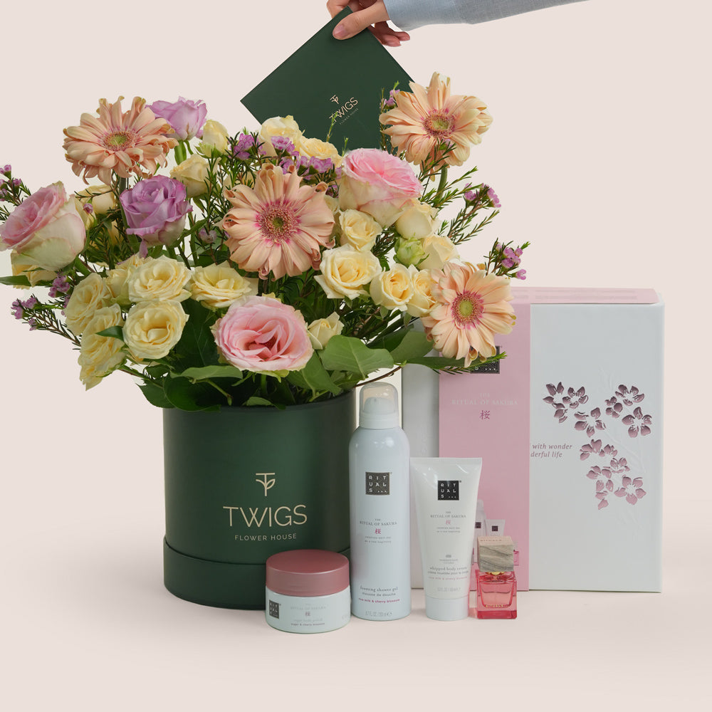 Mother’s Day flower arrangement with peach gerberas and roses in TWIGS green box paired with Rituals Sakura gift set