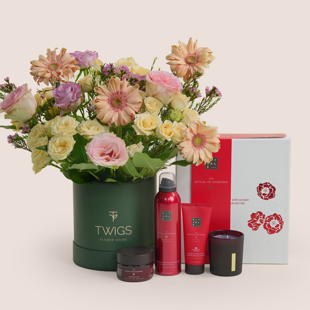 Mother’s Day flower arrangement with peach gerberas and roses in TWIGS green box paired with Rituals  gift set