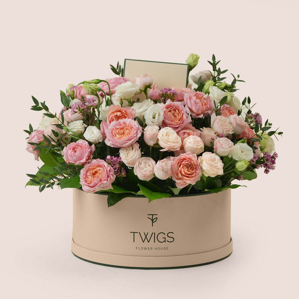 Mother’s Day flower arrangement with Juliet spray roses and white lisianthus in TWIGS green round flower box