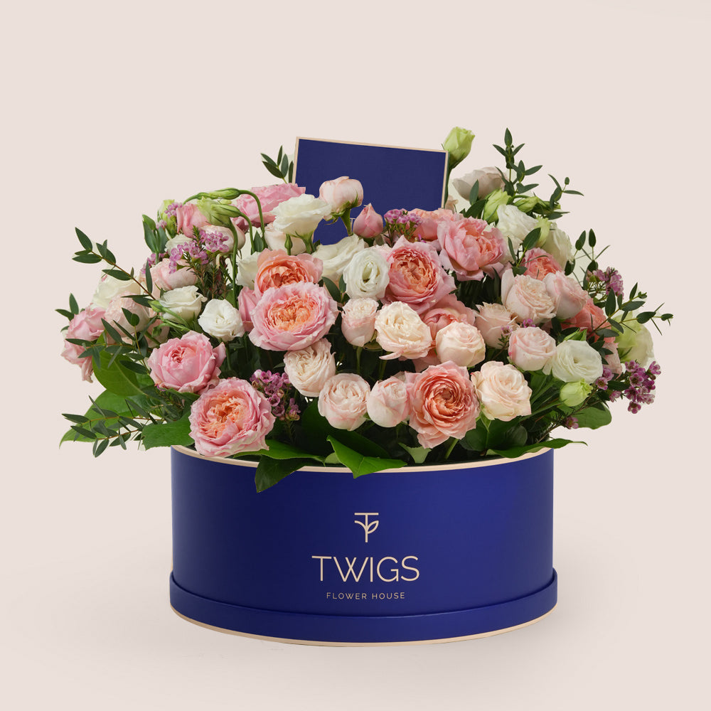 Blushing Bloom – Flower Arrangement in TWIGS Green Round Box