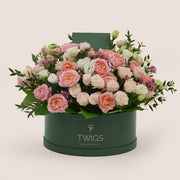 Mother’s Day flower arrangement with Juliet spray roses and white lisianthus in TWIGS green round flower box