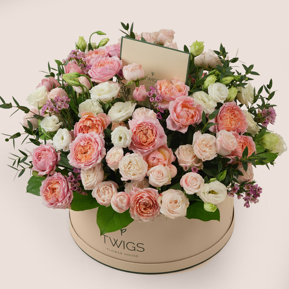 Mother’s Day flower arrangement with Juliet spray roses and white lisianthus in TWIGS green round flower box