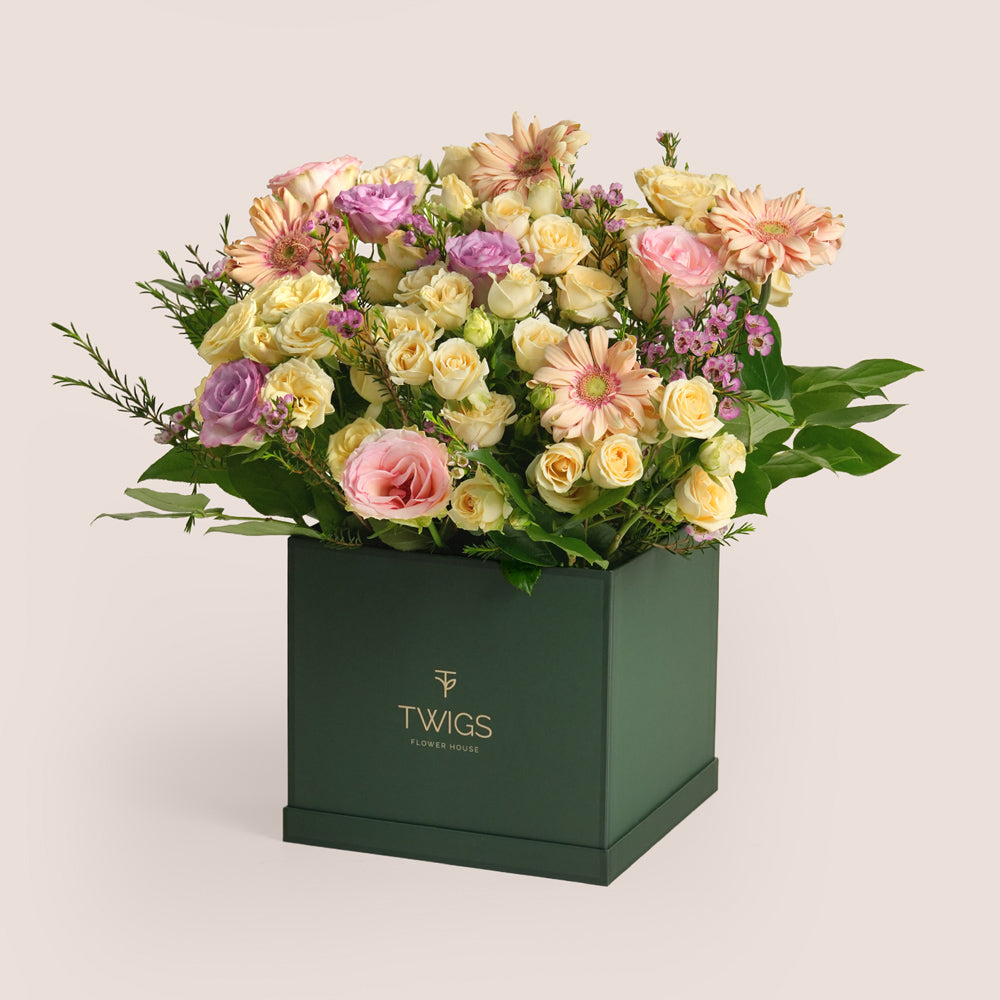 Mother’s Day flower arrangement with peach gerberas and roses in TWIGS square box paired with Rituals Ayurveda gift set