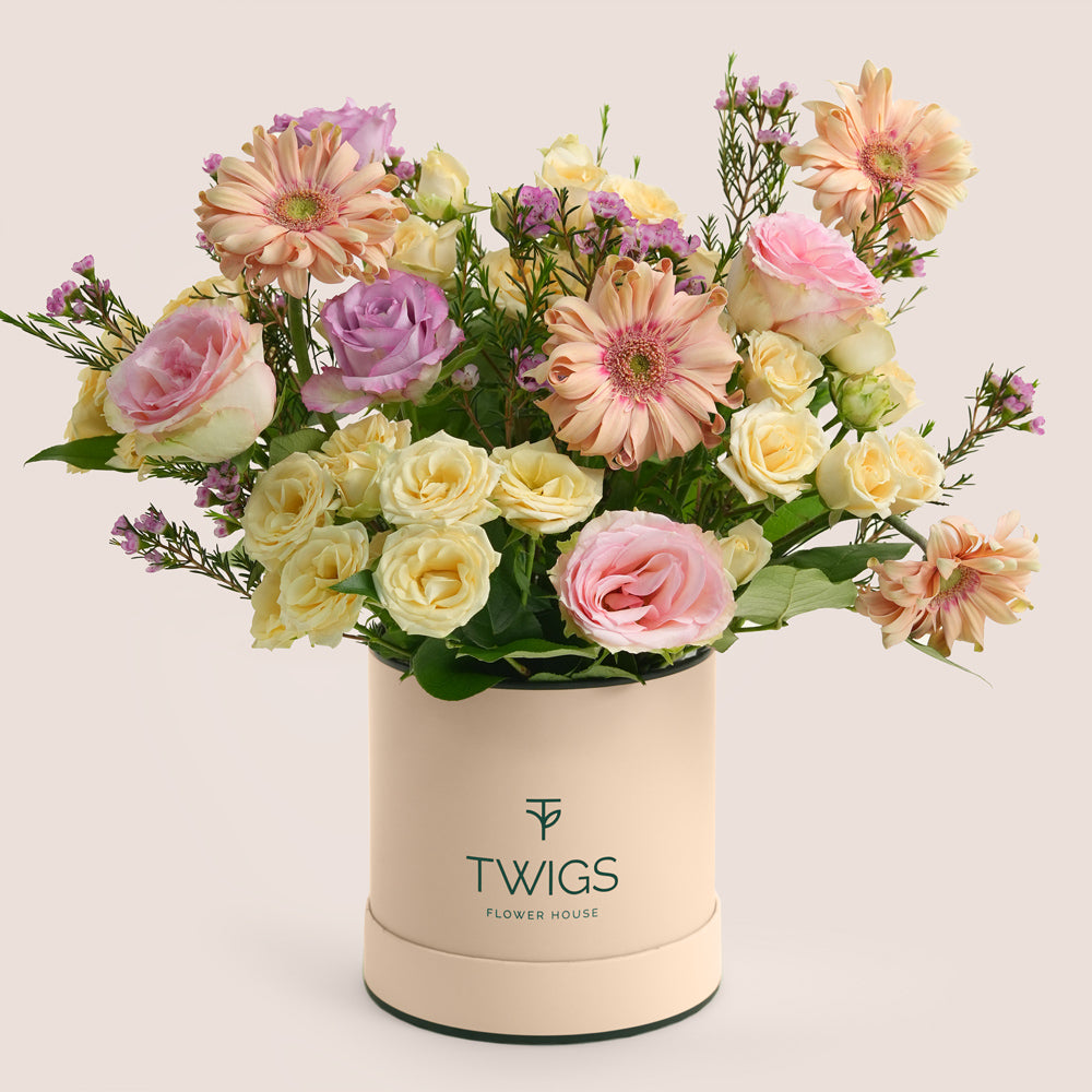 Mother’s Day flower arrangement with peach gerberas and roses in TWIGS deluxe round flower box