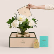 Ivory white peonies in glass vase with Al Lil perfume by Carmen Perfumes Dubai