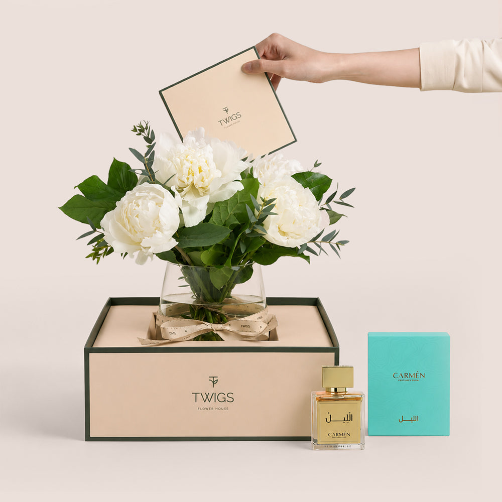 Ivory white peonies in glass vase with Al Lil perfume by Carmen Perfumes Dubai