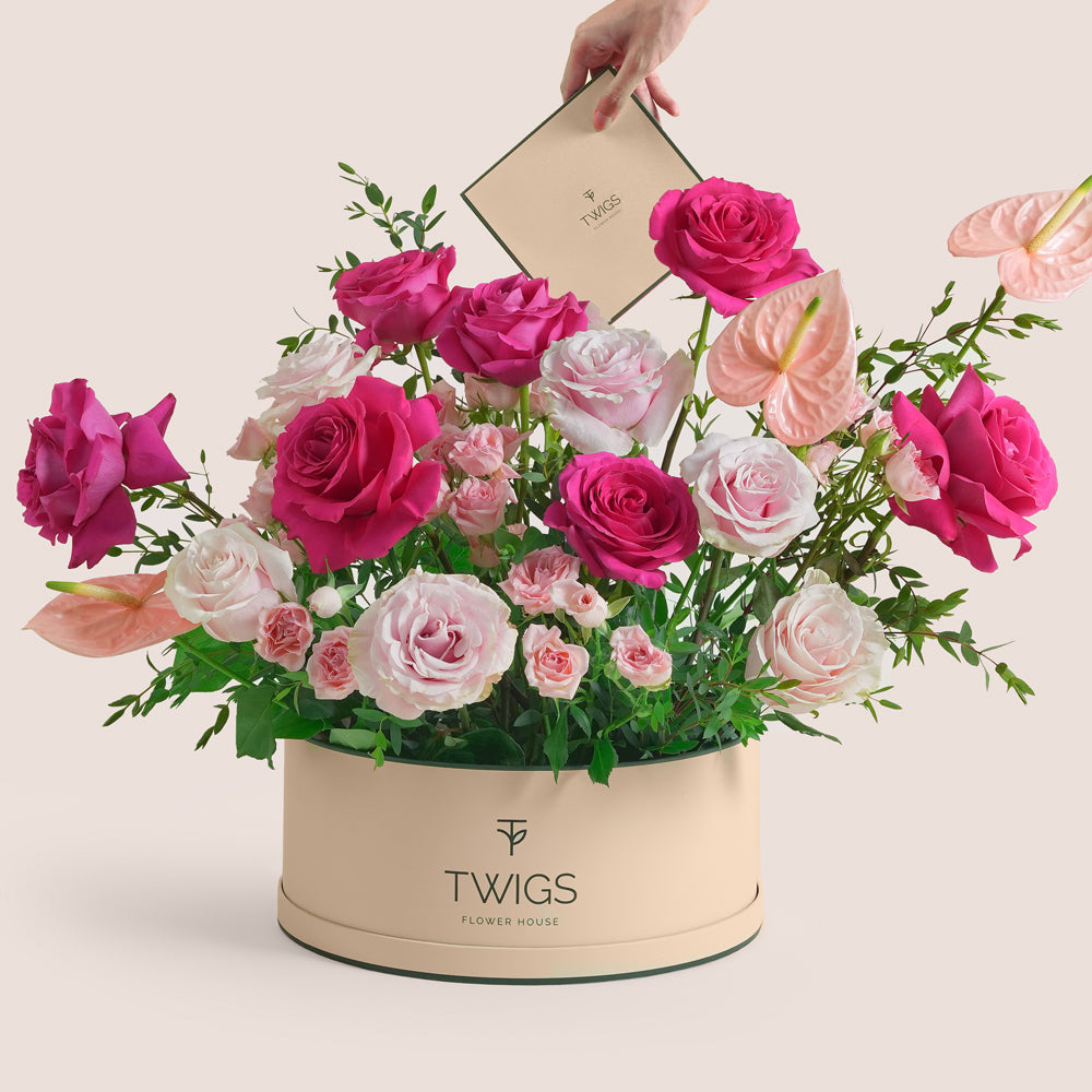 Blush anthurium and pink rose grande round flower box by TWIGS in beige