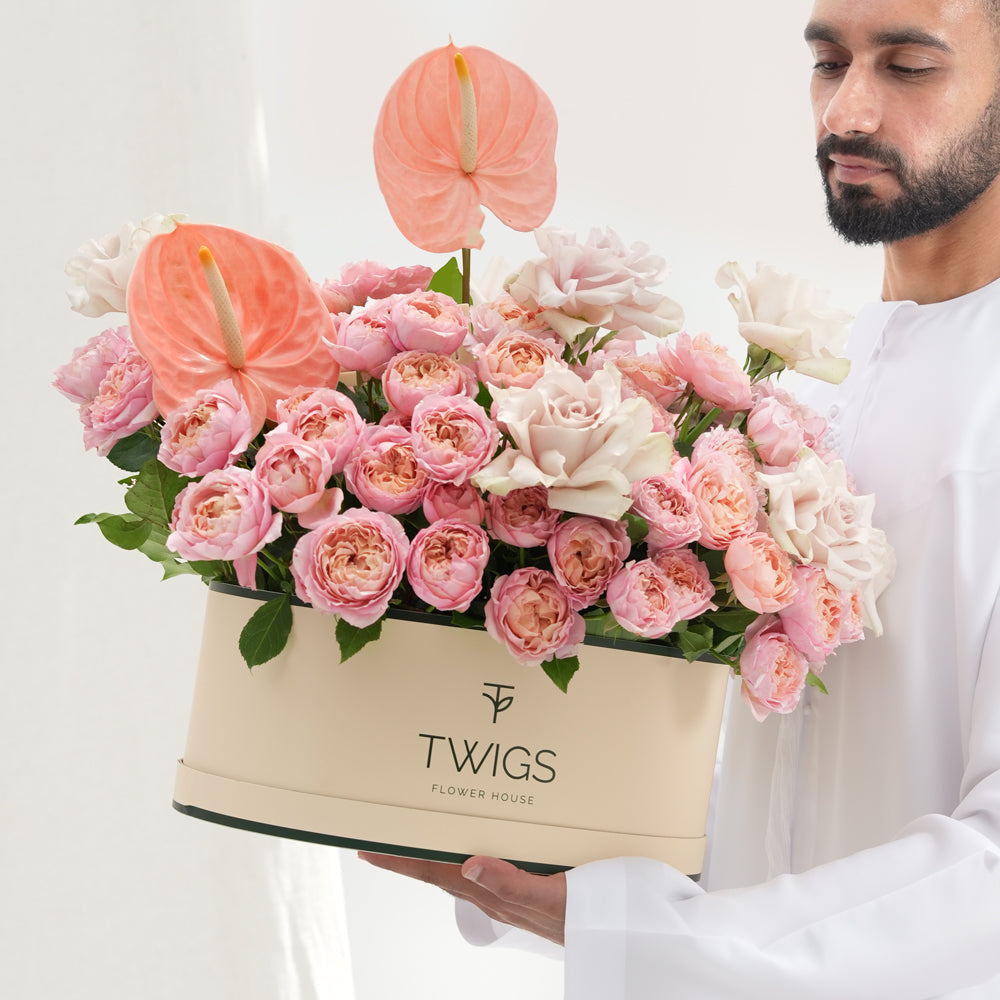 Pink and blush rose Grande round box with peach anthurium in TWIGS beige packaging — same-day Eid flower delivery UAE