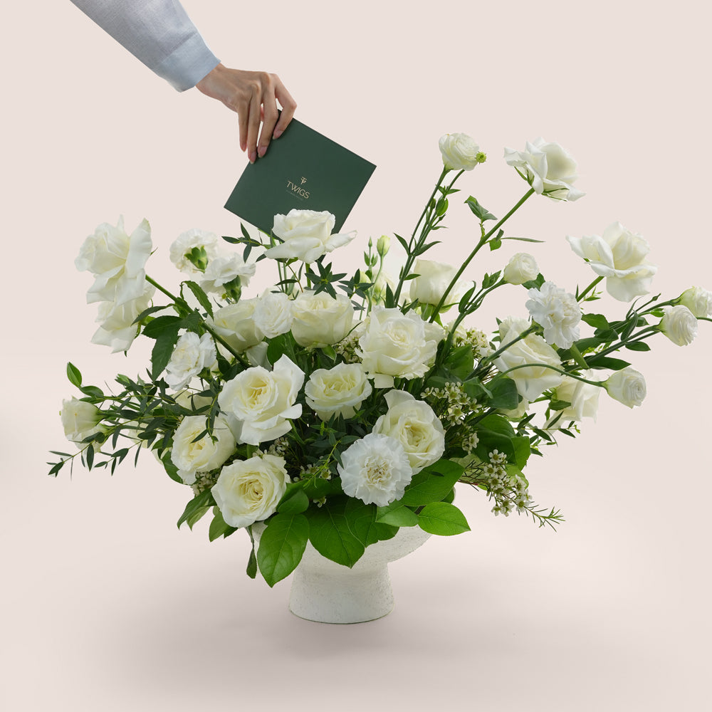 premium flower arrangement in white ceramic vase 