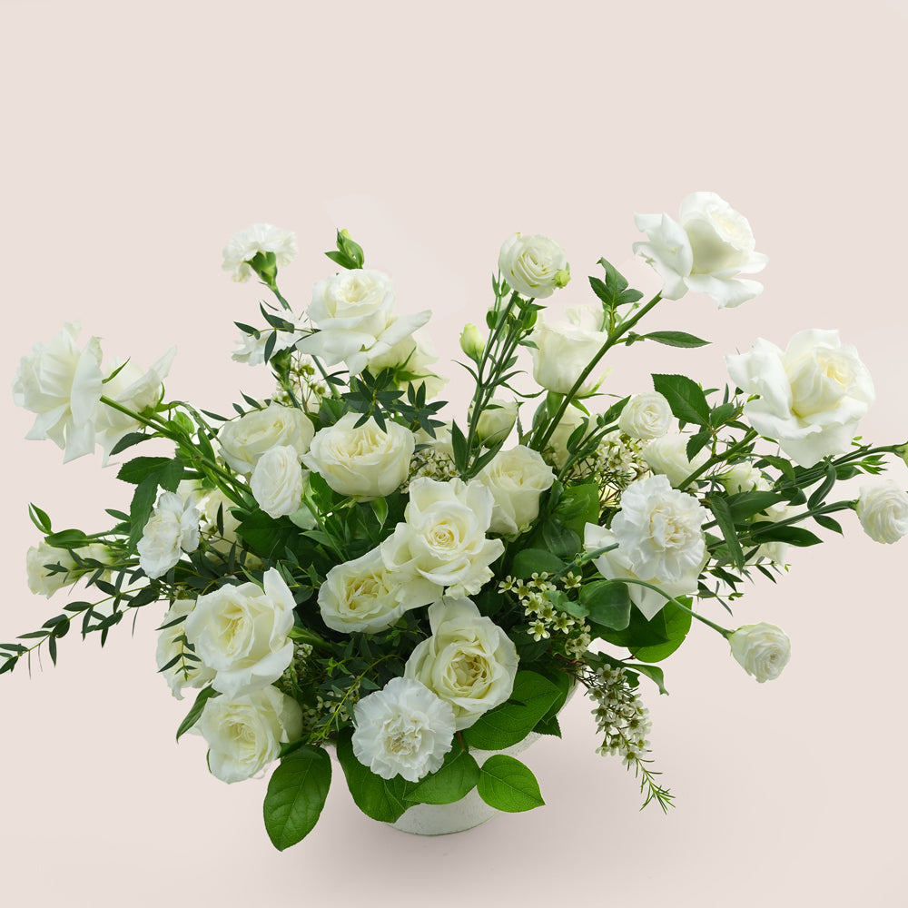 premium flower arrangement in white ceramic vase 