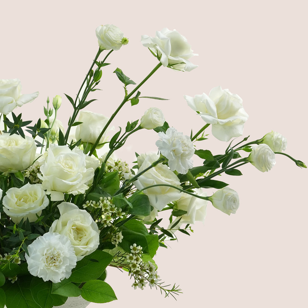 premium flower arrangement in white ceramic vase 