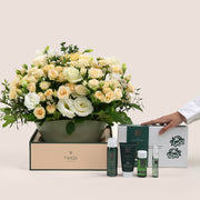 Floral arrangement  with TWIGS , accompanied by skincare products 