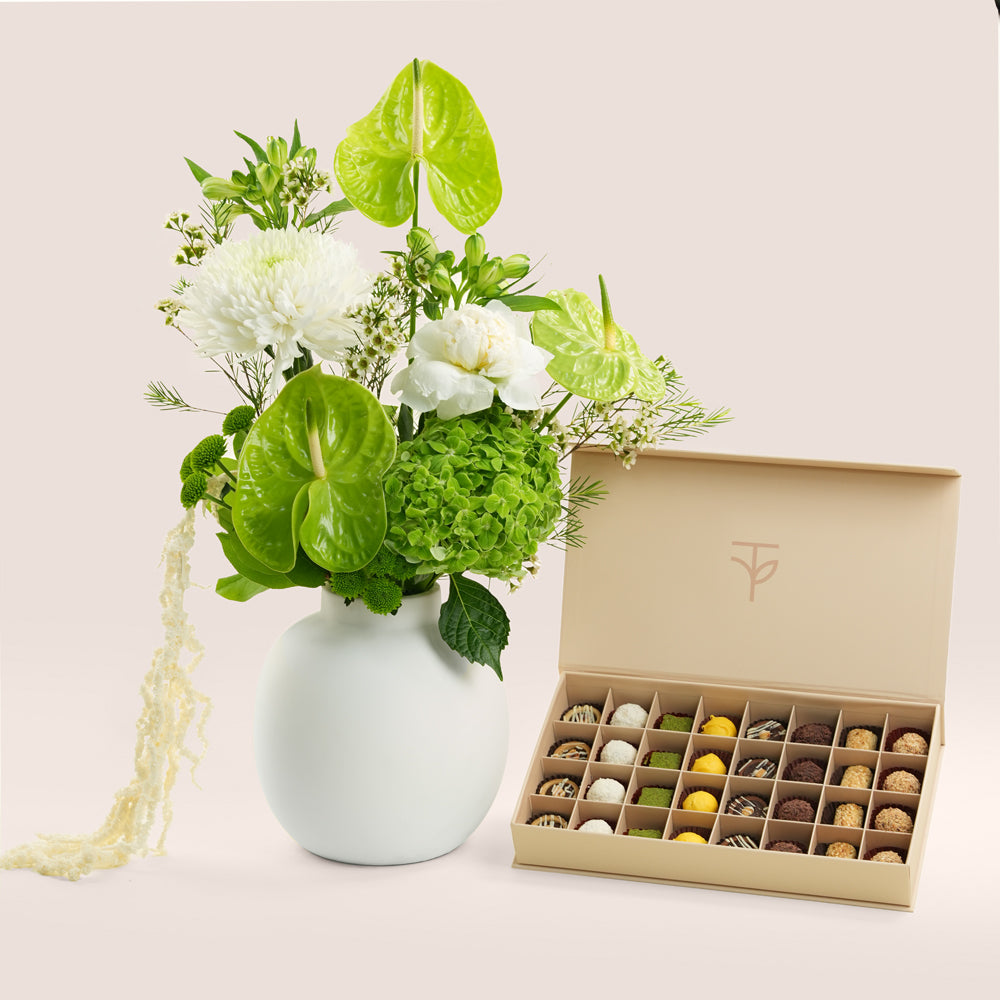 TWIGS Rif green and white botanical arrangement in ceramic vase with premium petite fours — same-day Eid gift delivery UAE
