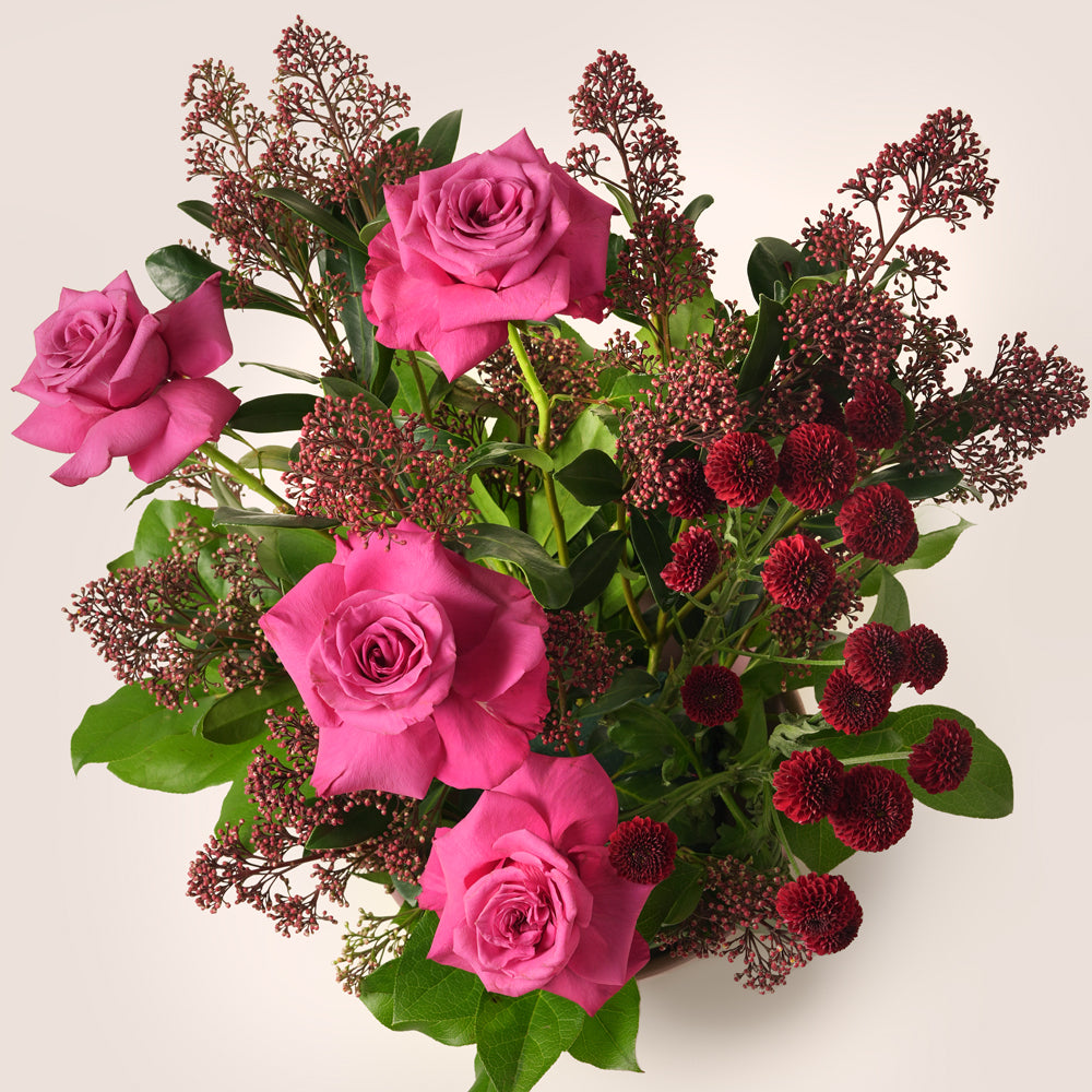 Premium pink rose arrangement with burgundy floral accents in blush vase – luxury flower delivery UAE