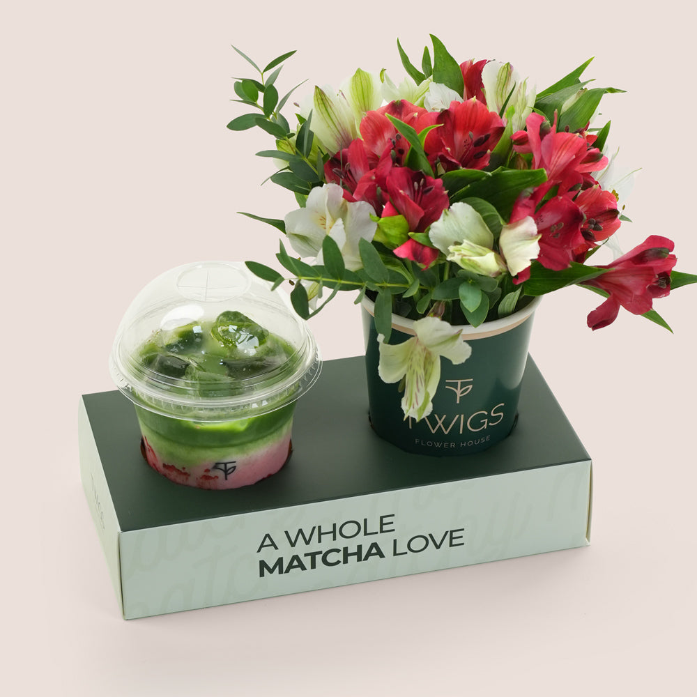 Matcha green tea drink and bouquet of flowers on a box labeled 'A Whole Matcha Love' with a light pink background.
