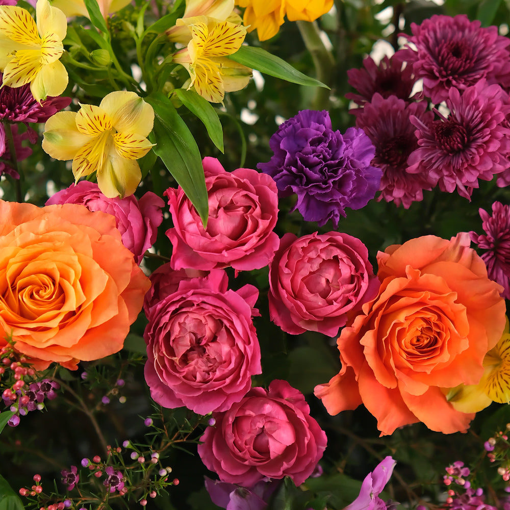 Bouquet of colorful flowers including roses and chrysanthemums.