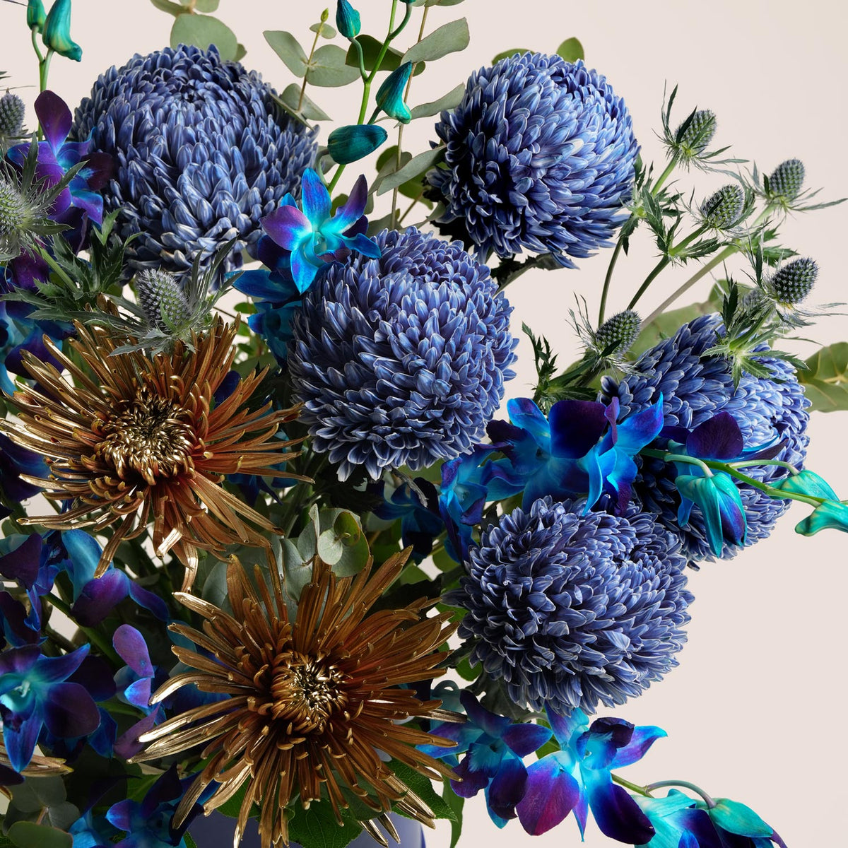 Blue orchids, blue chrysanthemums and bronze spider mums in a navy TWIGS flower box, a premium Diwali gift delivered in Dubai
