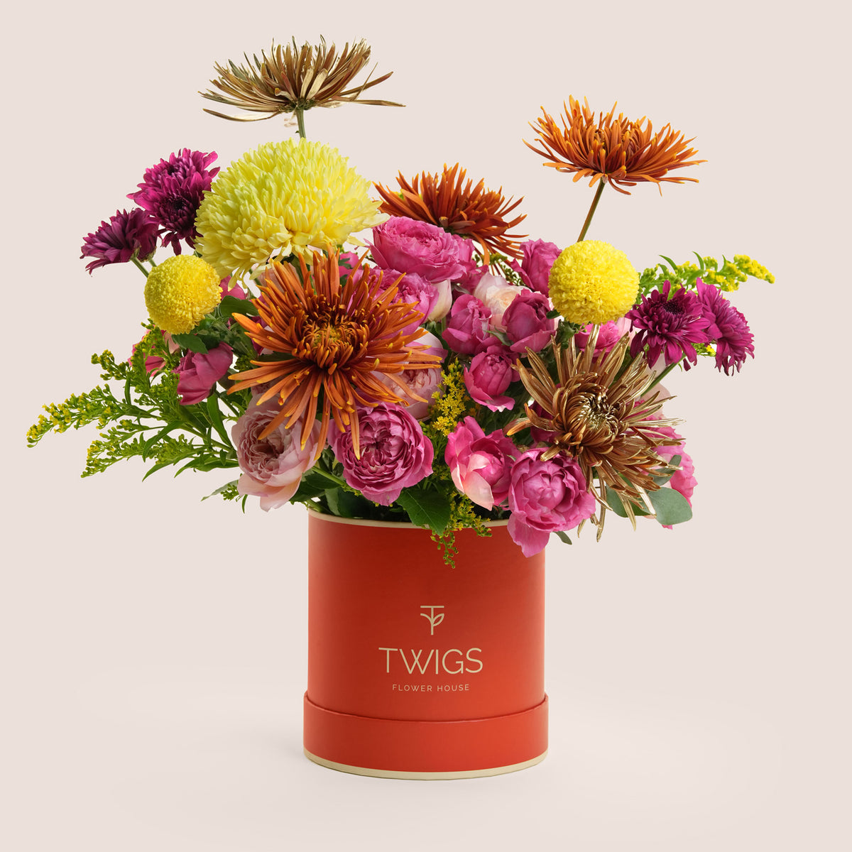 Pink roses, yellow and orange chrysanthemums in an orange TWIGS flower box, a colourful Diwali flower gift delivered in Dubai