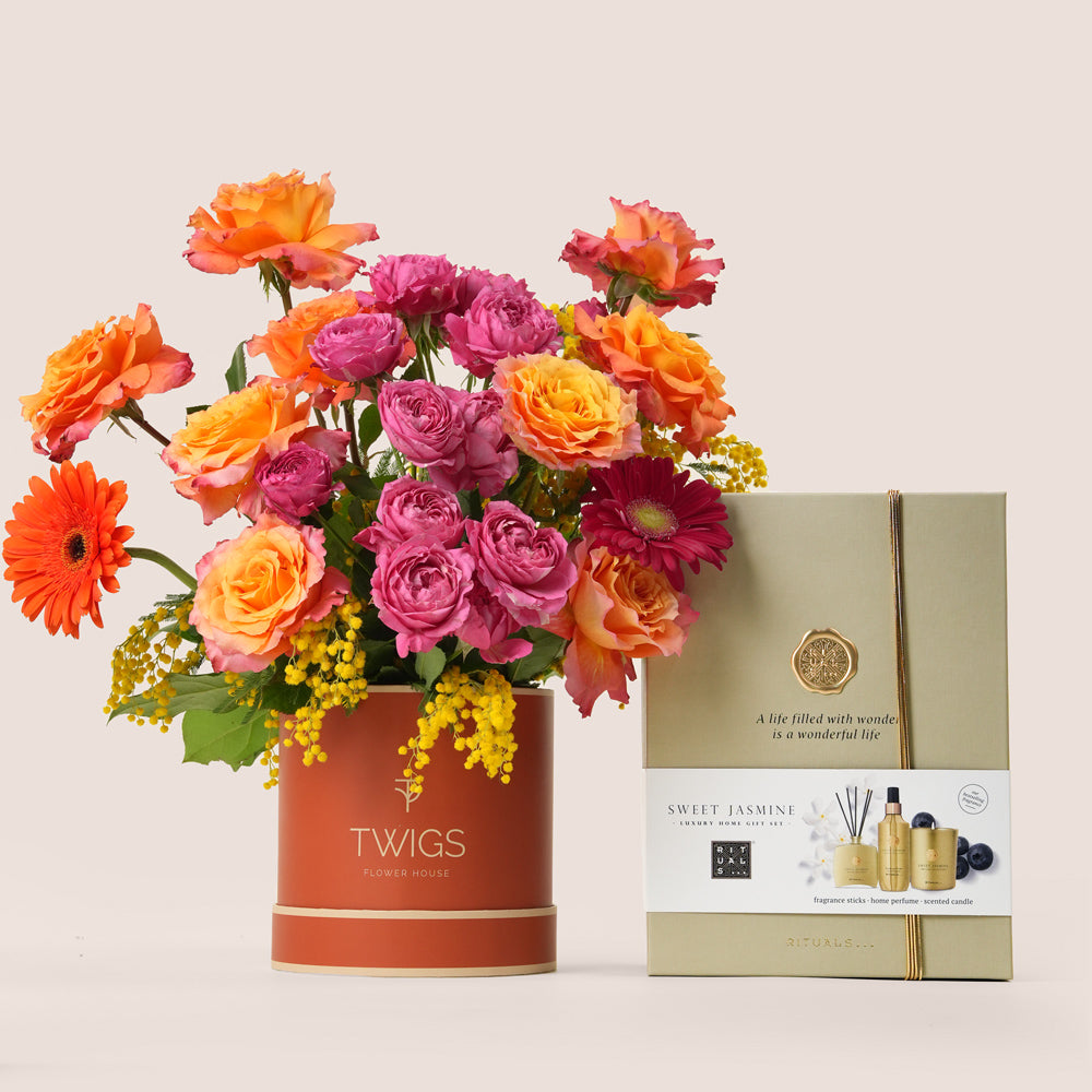Luxury Ramadan flower arrangement with orange roses and fuchsia spray roses paired with Rituals Sweet Jasmine candle and fragrance gift set – UAE delivery