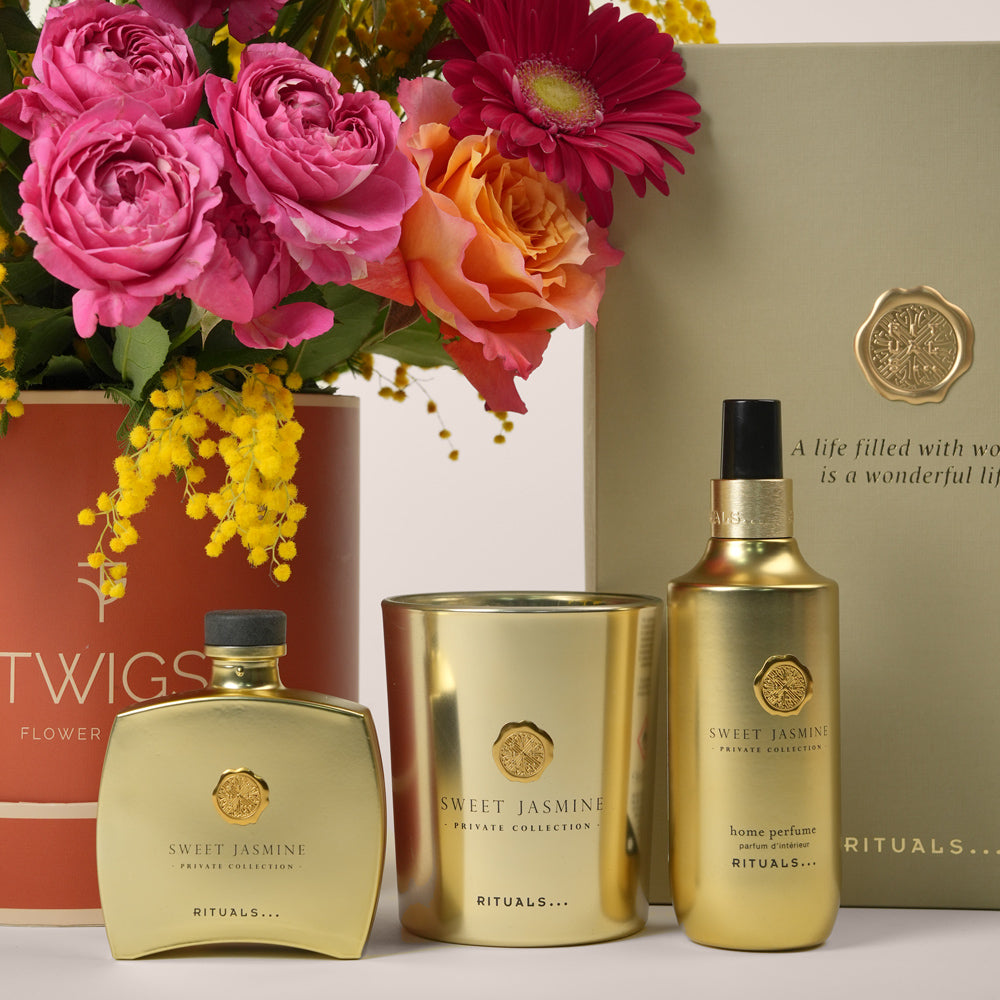 Luxury Ramadan flower arrangement with orange roses and fuchsia spray roses paired with Rituals Sweet Jasmine candle and fragrance gift set – UAE delivery