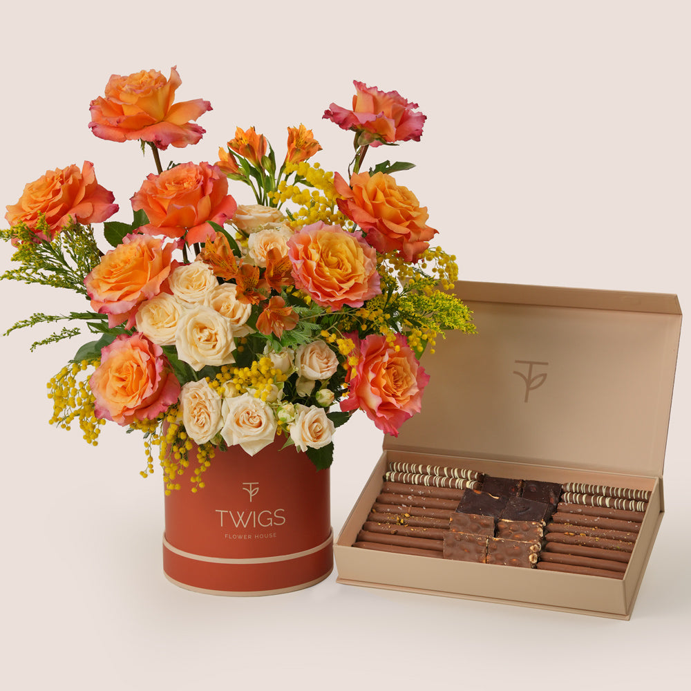Luxury Ramadan flower arrangement with orange Ecuador roses paired with TWIGS signature chocolate gift box – UAE same-day delivery