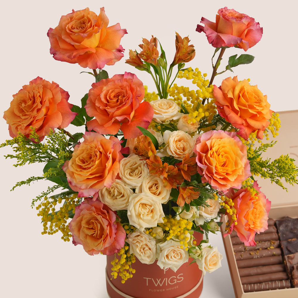 Luxury Ramadan flower arrangement with orange Ecuador roses paired with TWIGS signature chocolate gift box – UAE same-day delivery