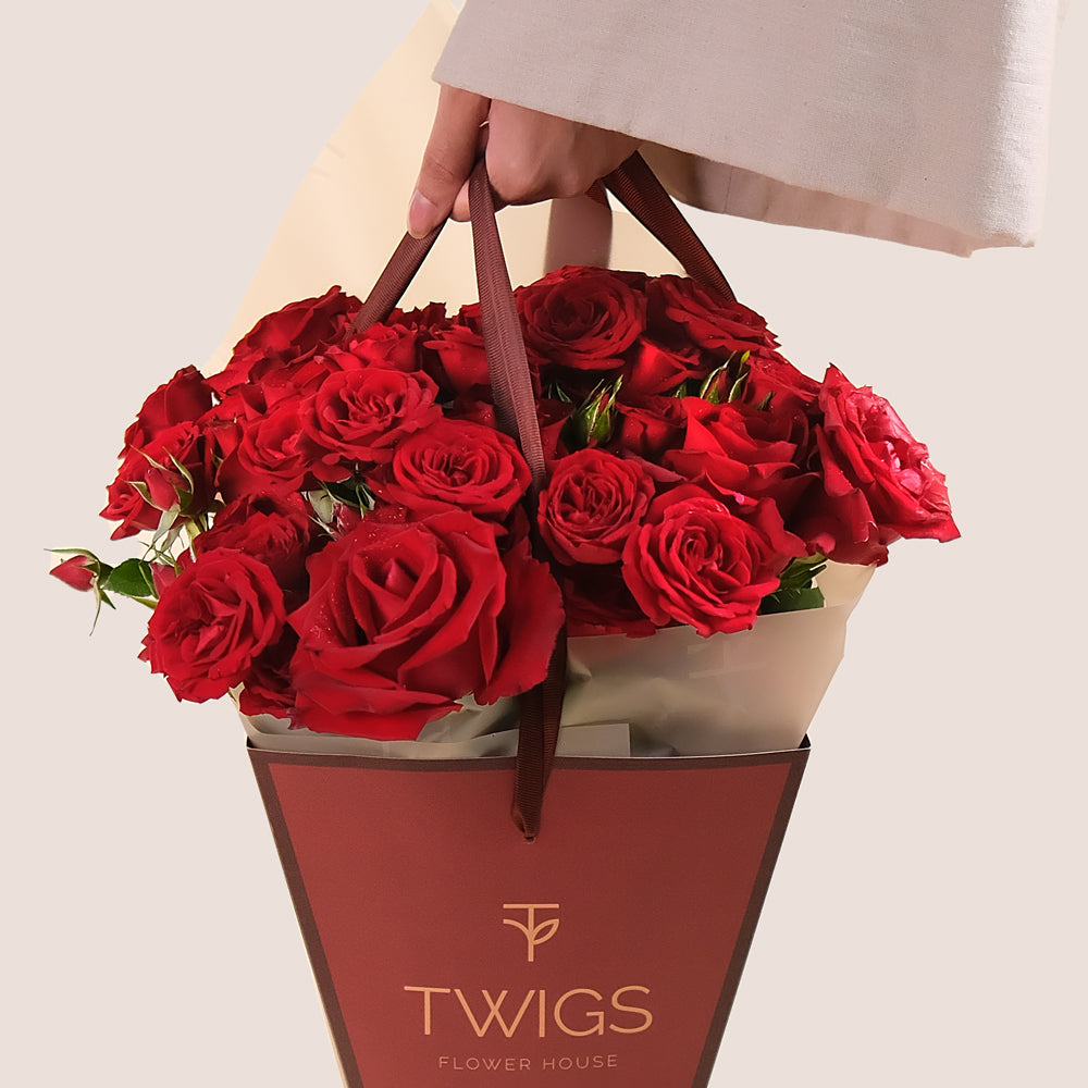 Very Red Charm red rose arrangement in limited edition cone bag.  Same day flower deliver in Dubai.