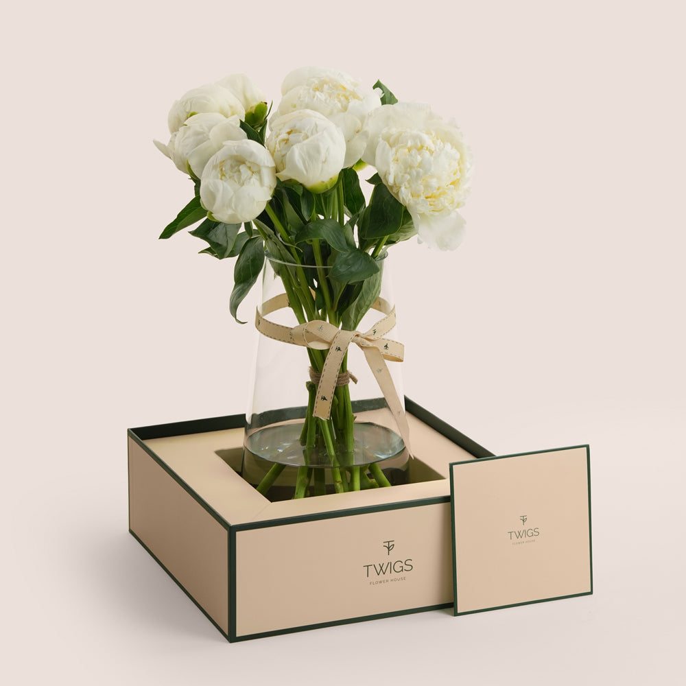 White peony tall vase arrangement in TWIGS forest green signature box — Eid Al Adha flower delivery Dubai