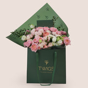 Blushing Bloom Mother’s Day flower arrangement with Juliet spray roses and white lisianthus in TWIGS signature flower bag