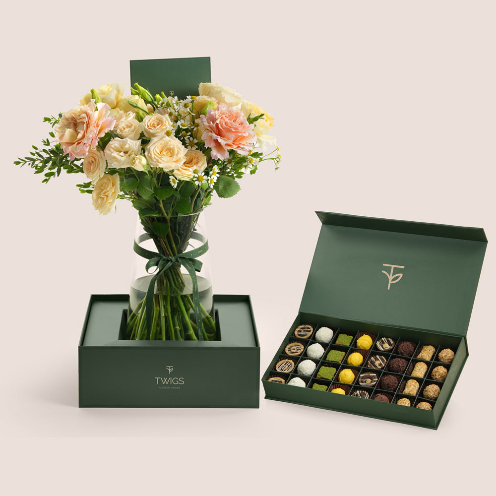 Blush rose vase and premium truffles assortment in TWIGS forest green box — flowers and chocolate Eid gift delivery UAE
