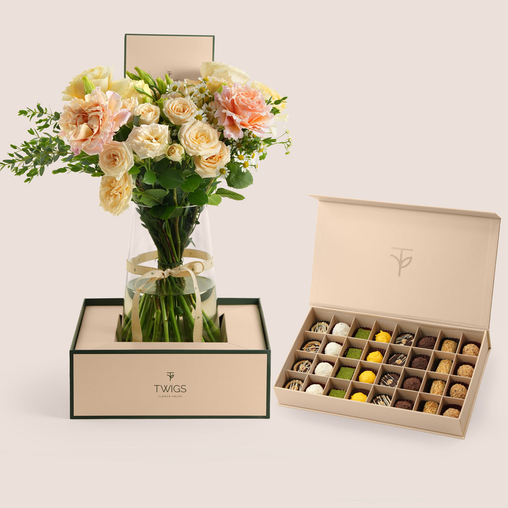 Pastel rose vase arrangement with 32-piece truffle and petite fours box in TWIGS beige packaging — Eid Al Adha gift set Dubai