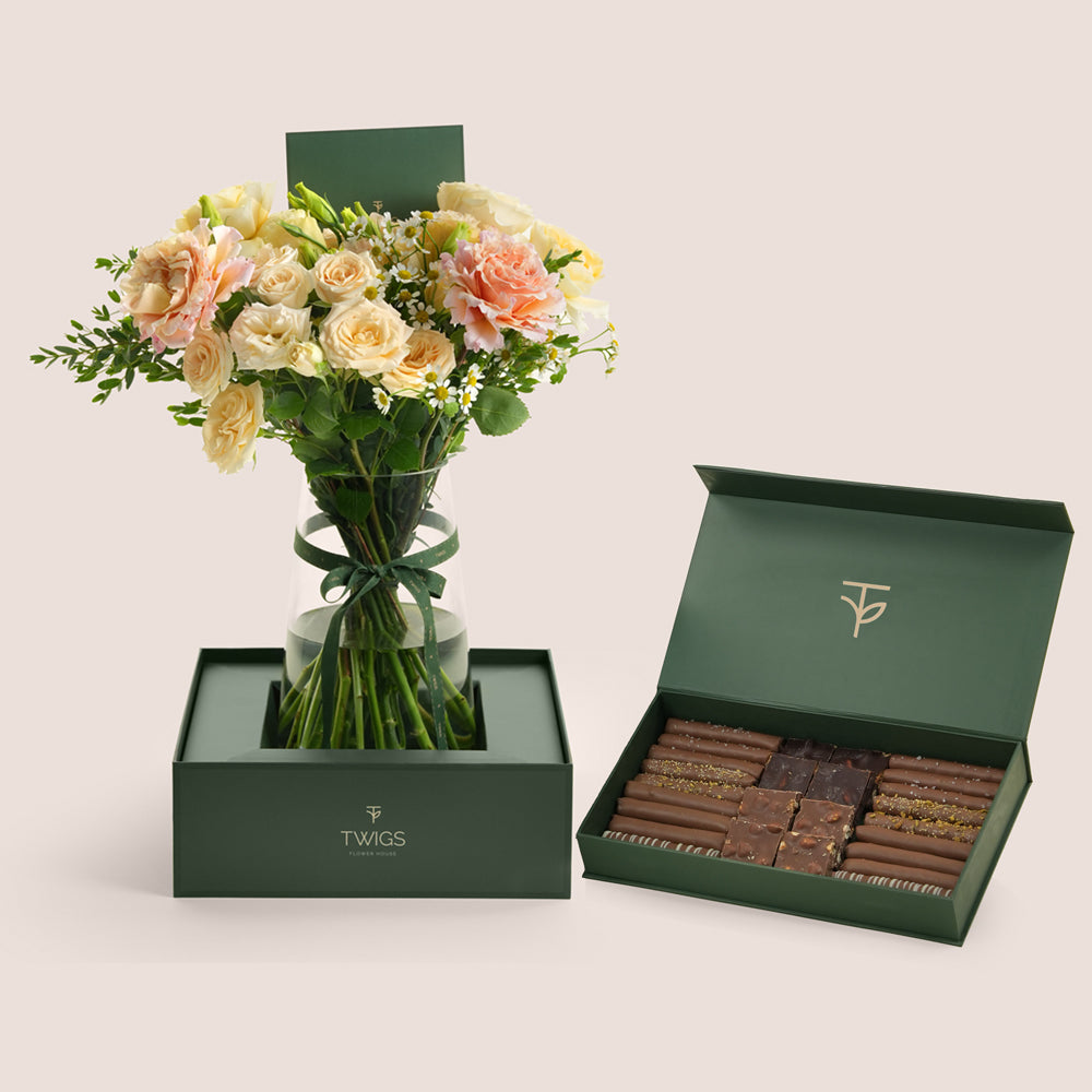 Blush rose vase and chocolate box in TWIGS forest green packaging — flowers and chocolate Eid gift delivery UAE
