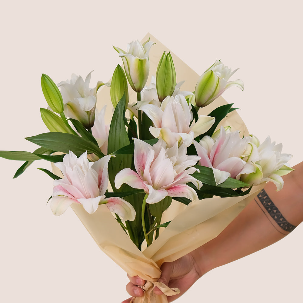 Double Petalled Lilies in TWIGS Cone-Shaped Carry Bag– Elegance in Every Petal