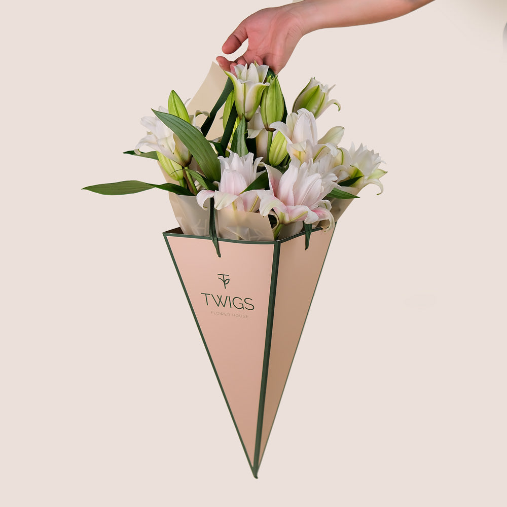 Double Petalled Lilies in TWIGS Cone-Shaped Carry Bag– Elegance in Every Petal