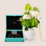 Green and white botanical vase arrangement with Carmen Gift Box Season perfume set