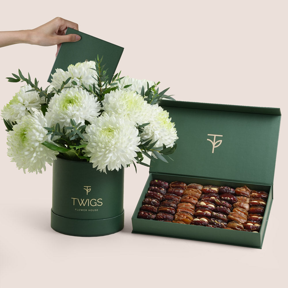 White Magnum Mum chrysanthemums in a green round flower box paired with premium assorted stuffed dates and nuts by TWIGS Flower House