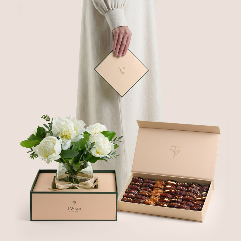 White peonies in a glass vase paired with a premium assorted stuffed dates and nuts gift box by TWIGS Flower House