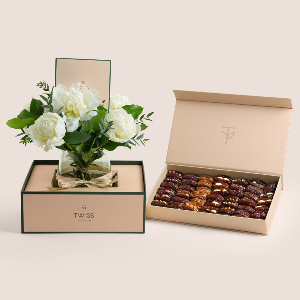 White peonies in a glass vase paired with a premium assorted stuffed dates and nuts gift box by TWIGS Flower House